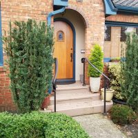 Black handrail leading to a doorway