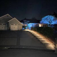 Clear railing outside of a home at night